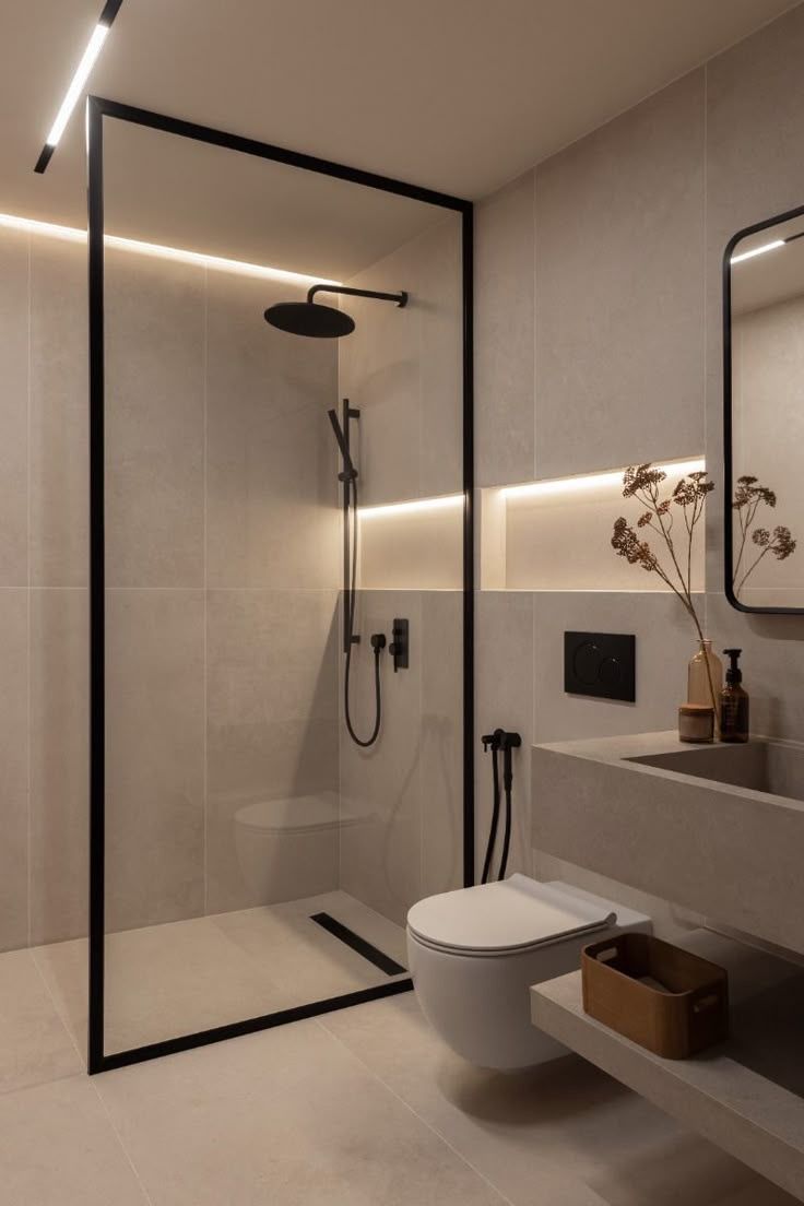 Baño a medida con mampara negra y líneas minimalistas